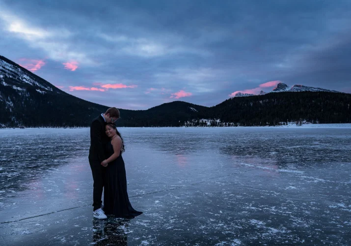 Romantic moment before the proposal. Couple hug each other during winter morning in Banff.