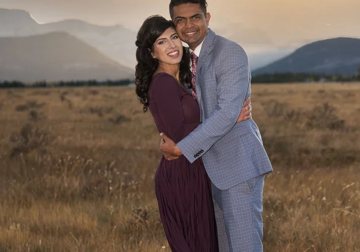 Smiling newly engaged couple posing to 4Eyes Photographer in Banff.