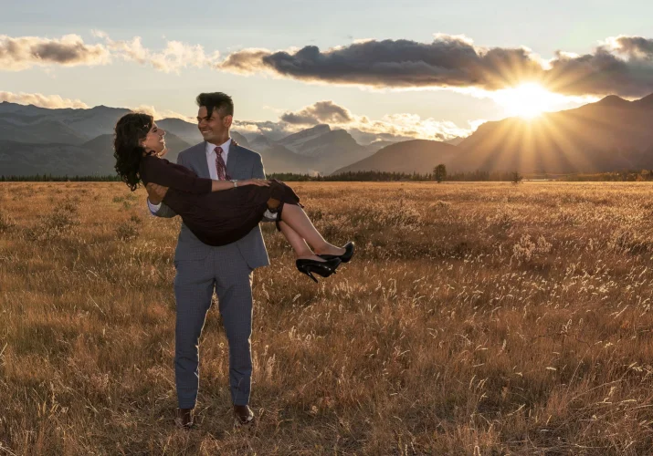 A man carry his new fiancée on his hands during engagement shoot in Banff National Park.