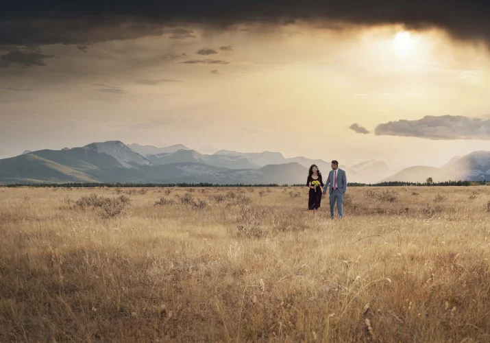 engaged couple walks in Banff during fall sunrise