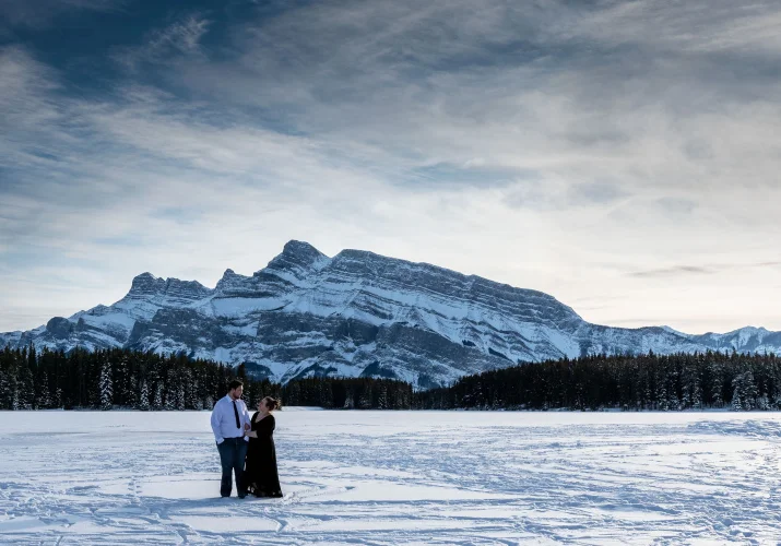 Engaged couple is posing for 4Eyes Photography during engagement photo session.