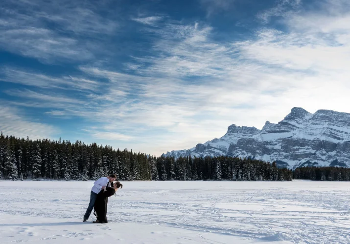 Engaged couple dancing in the snow. Banff engagement Photography.