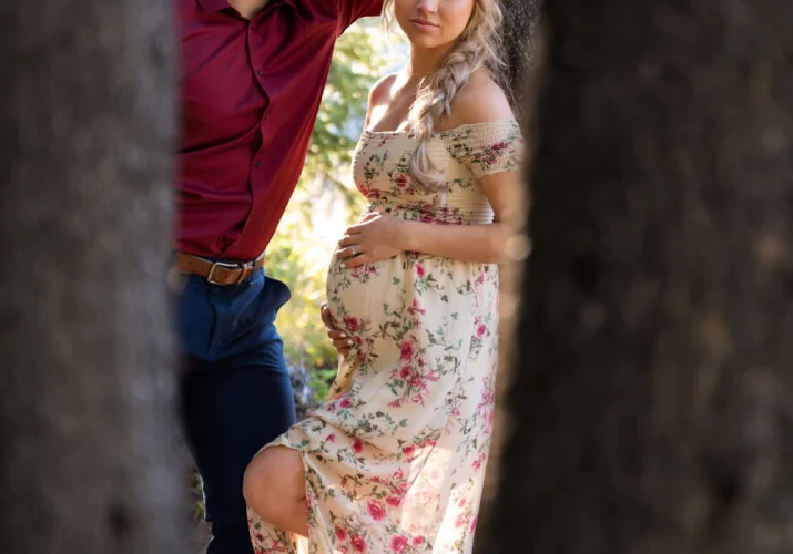 Future father looks with love on his pregnant wife. Pregnancy shoot in Banff.