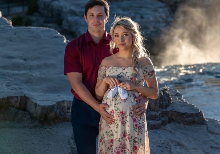 Future parents posing during maternity photo shoot in Banff.