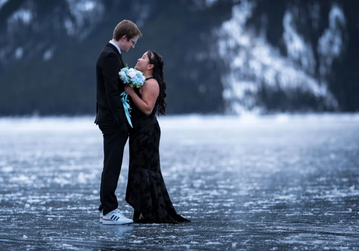 Young couple looking into each others eyes during romantic proposal.