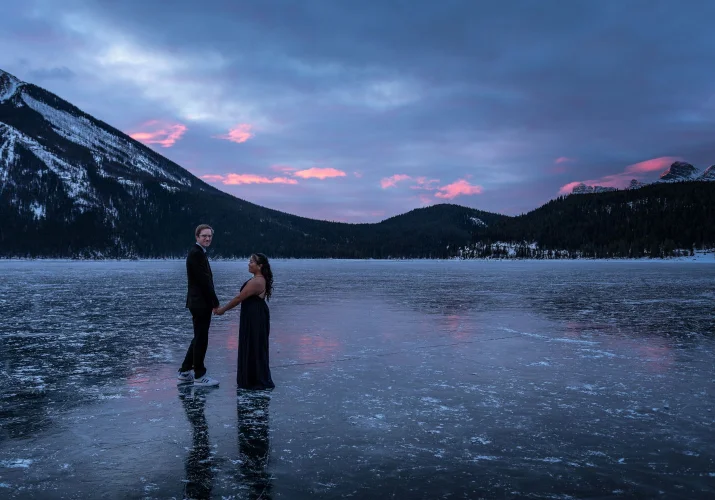 Romantic walk at Minnewanka Lake during winter sunrise