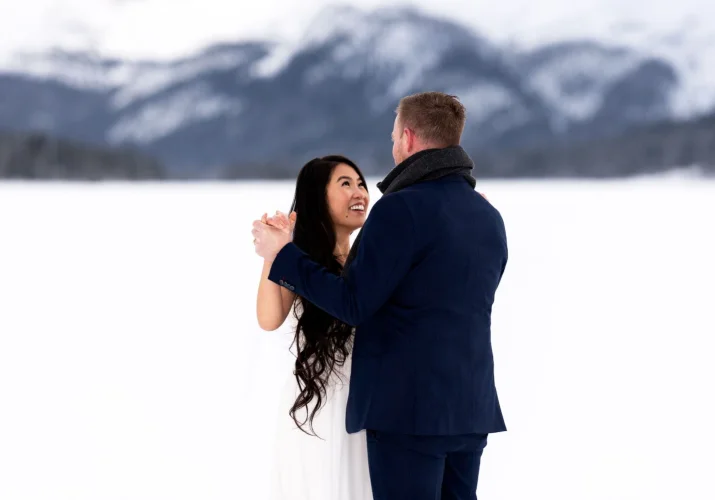 Bride and groom are dancing during their winter wedding in Banff