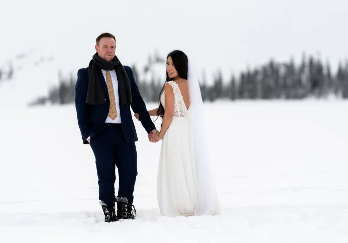 Married couple simile at the camera during after wedding session in Rocky Mountains