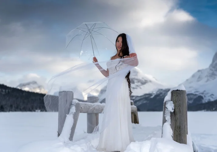 Bride holds an umbrella