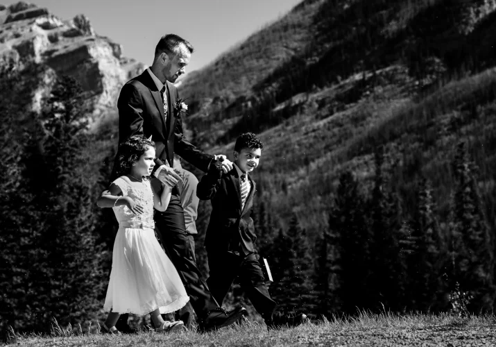Groom holding his kids hands