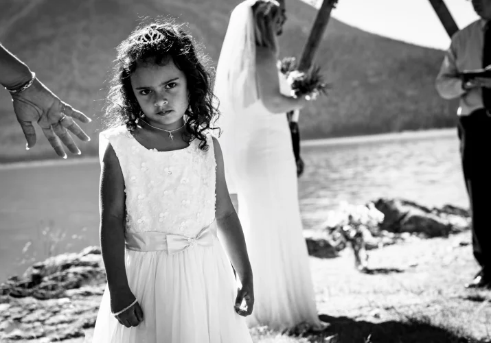 Cute child look at the camera during wedding ceremony in Banff at Minnewanka Lake