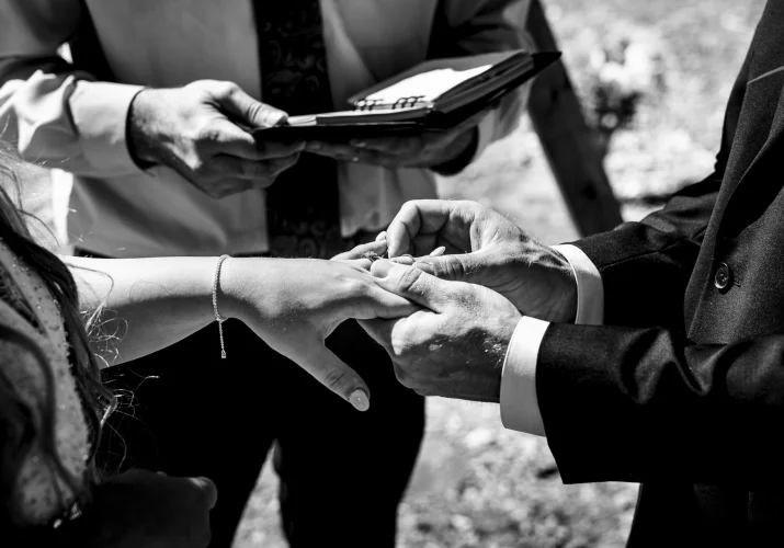 Groom puts a wedding ring on the bride's finger