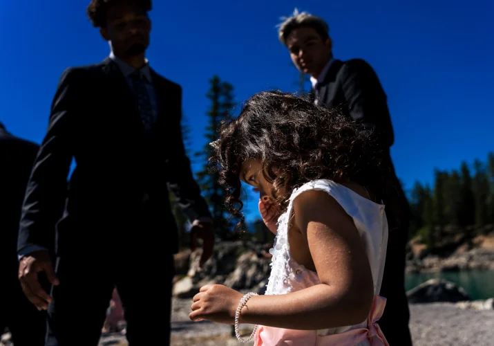 # year old daughter of the Bride cries during the ceremony at Minnewanka Lake. Banff