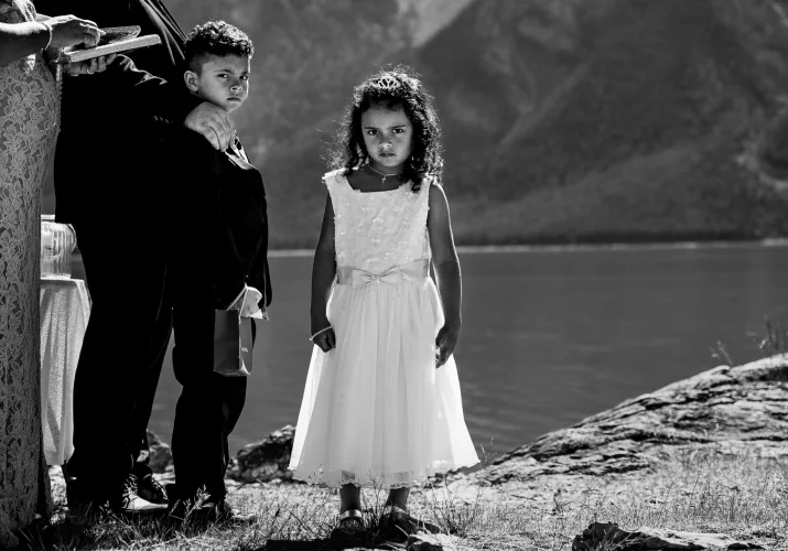 Bride's children's during elopement ceremony looking at the camera. Black and White photo.