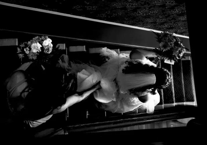 The bride is rushing to be on time for Calgary Wedding. She is running down the stairs.