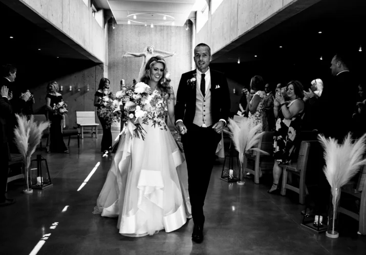 Happy Newlyweds living the church after their wedding ceremony.