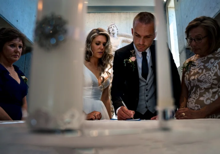 The groom signing the wedding papers
