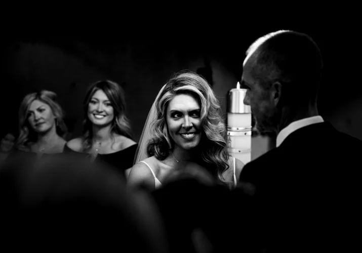 The bride is looking and smiling to the groom.