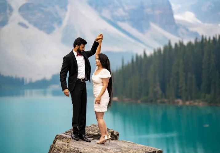 Engaged couple dandling at Moraine Lake during the sunrise.