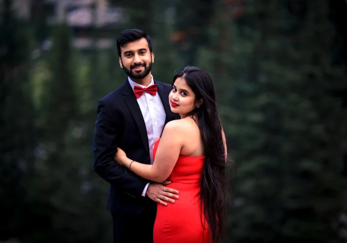 Engaged couple look at the camera during their engagement photog session at Moraine Lake.