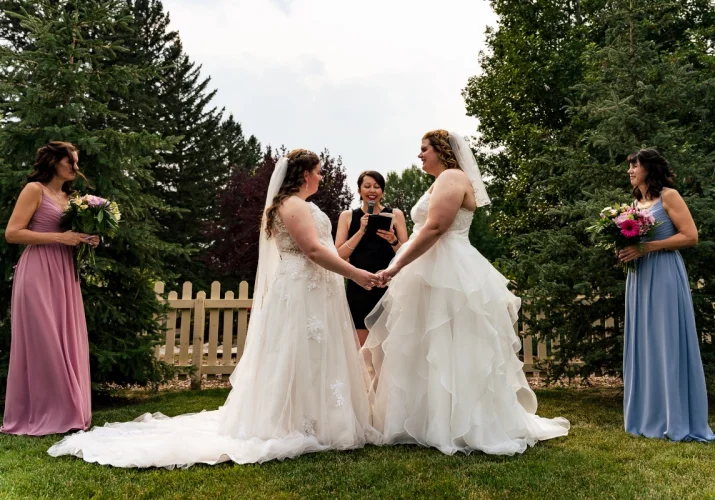 Same sex couple Calgary Wedding Photography. The brides are holding their hands and look deep at each others eyes.