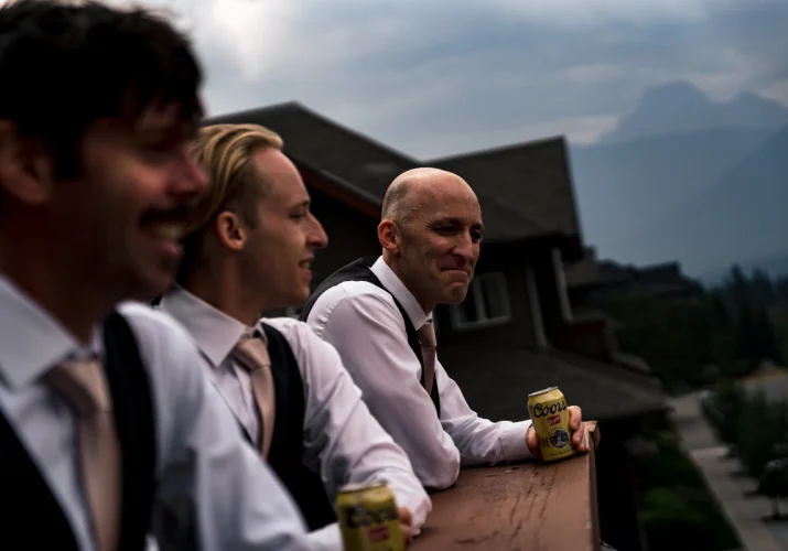 Calgary Wedding Photographer is capturing groom's and best man's good time. They are drinking a beers