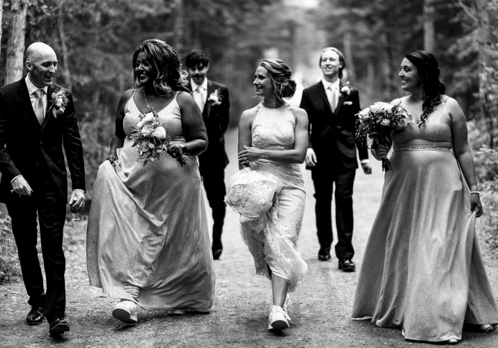 happy bridal party having fun during their photo session with the best Calgary Wedding Photographer