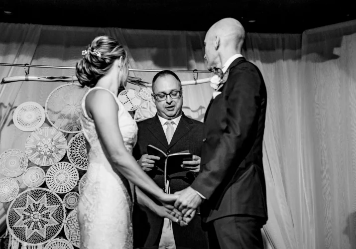 Bride and groom holding their hands during the ceremony