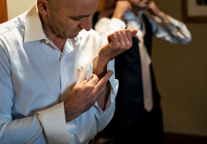 groom dressing up for the wedding
