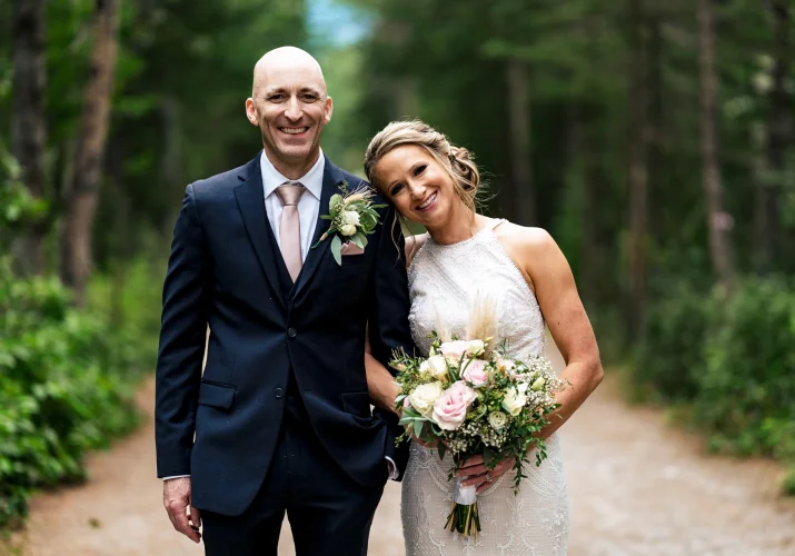Bride's and Groom's Portrait. They are looking at the camera's of Calgary Wedding Photographer