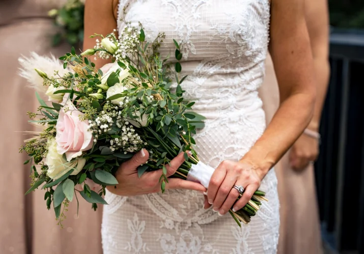 bride is holding a bouquet