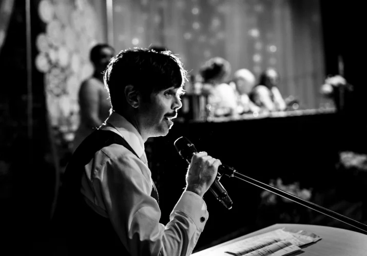 Best man is giving a speech captured by Calgary Wedding Photography