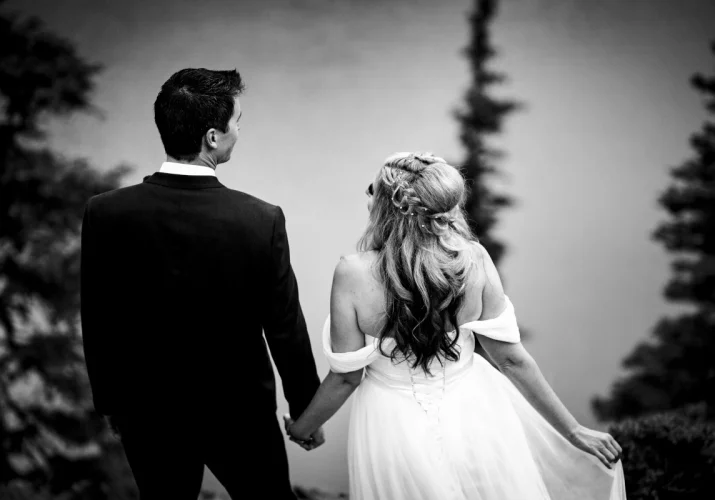bride and groom standing back to the camera