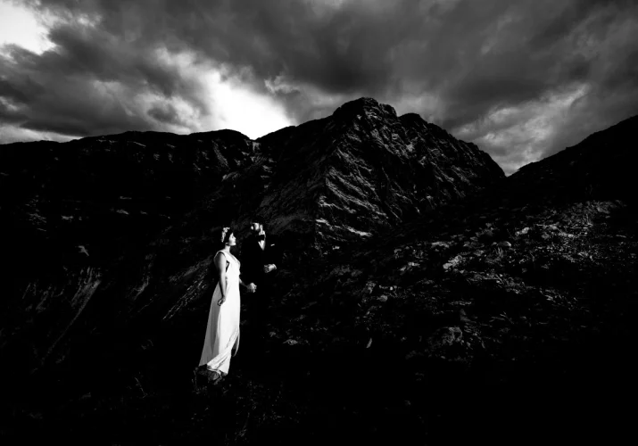 Groom and Bride look at the tremendous Canadian Rockies during Wedding Mountain Session in Banff.