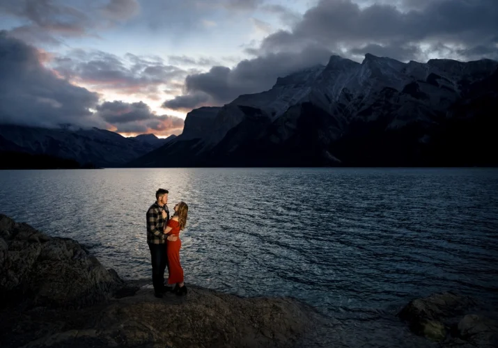 Couple in love look at each others eyes during engagement photo session in Banff National Park