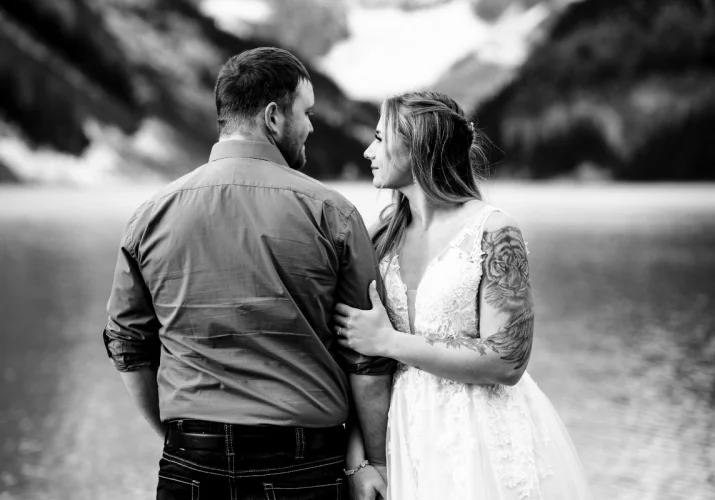 Groom and bride glance at each other.