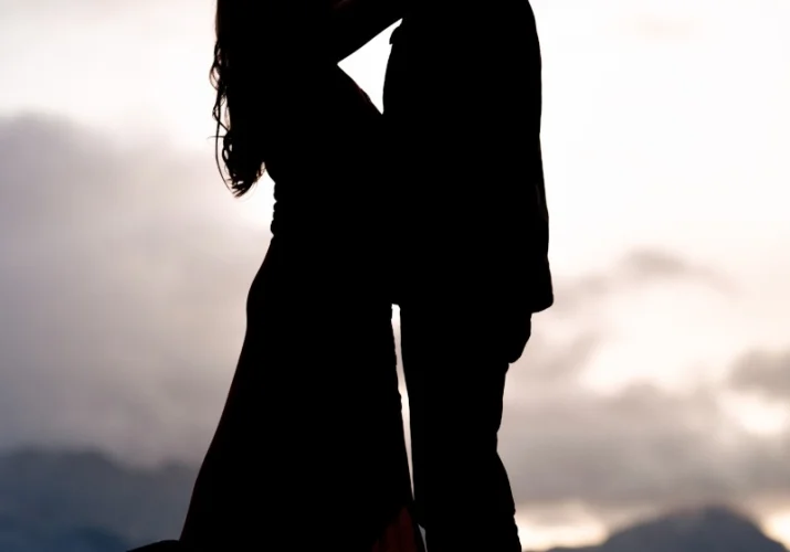 Engagen couple hug each other and look deeply at each other eyes in Banff