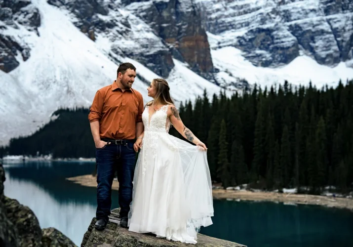 Groom and Bride deeply into each others eyes at Moraine Lake during wedding portrait photo session taken by Calgary Wedding Photographer.