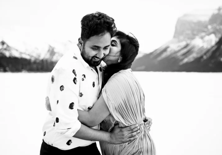 Indian girl whispers a secret to her husband ear.