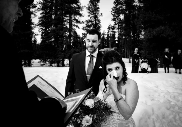 Bride cries during wedding ceremony in the Canadian Rockies.