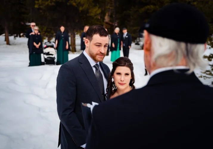 Bride and groom listen to commissioner during Banff elopement.