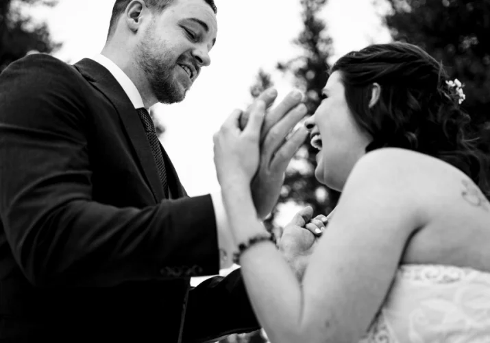 Happy newlyweds smile to each others.