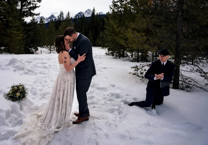 Newlyweds first kiss. Commissioner fall into a deep snow.