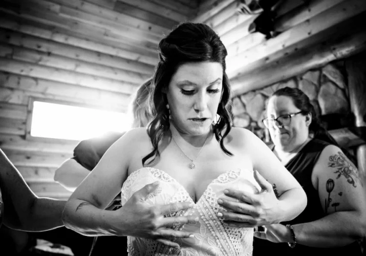 Bride puts a wedding dress on.