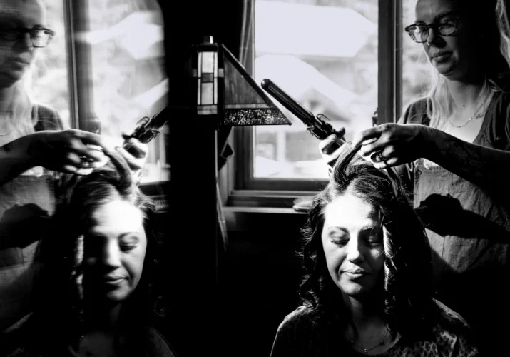hairstylist work on bridesmaid hair