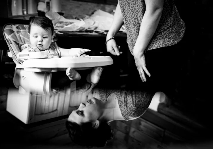 creative photo of mother and a baby. Mirror reflection in black and white.