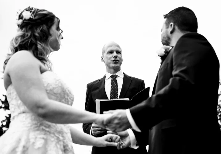 Officiant marry the bride and groom . Photo in black and white by Banff Wedding Photographers.
