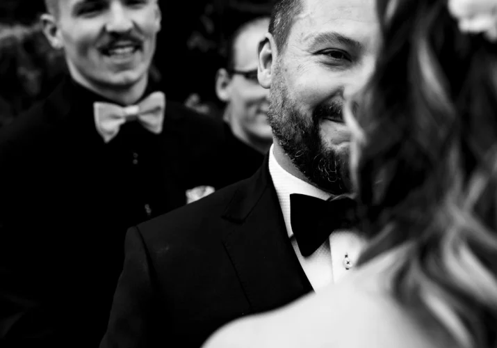 groom with tears in his eyes during Banff Wedding. Best-man smiles.