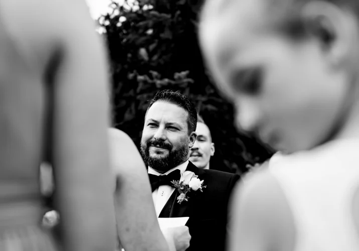 Groom's speech in black and white with flower girl on the foreground.
