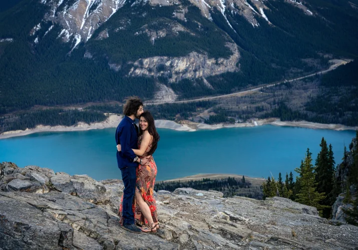 Canadian posed couple standing on the peak on the mountain,